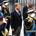 Britain’s Prince Harry, Duke of Sussex, stands next to King Charles, Anne, Princess Royal, and William, Prince of Wales, as they salute during the state funeral and burial of Britain’s Queen Elizabeth.